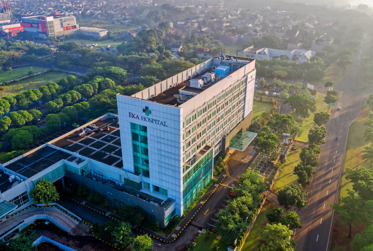 Mastering the First Impression: Your intriguing post title goes here Discover the contemporary architecture of Eka Hospital from an aerial perspective, surrounded by lush greenery in Serpong, Indonesia.